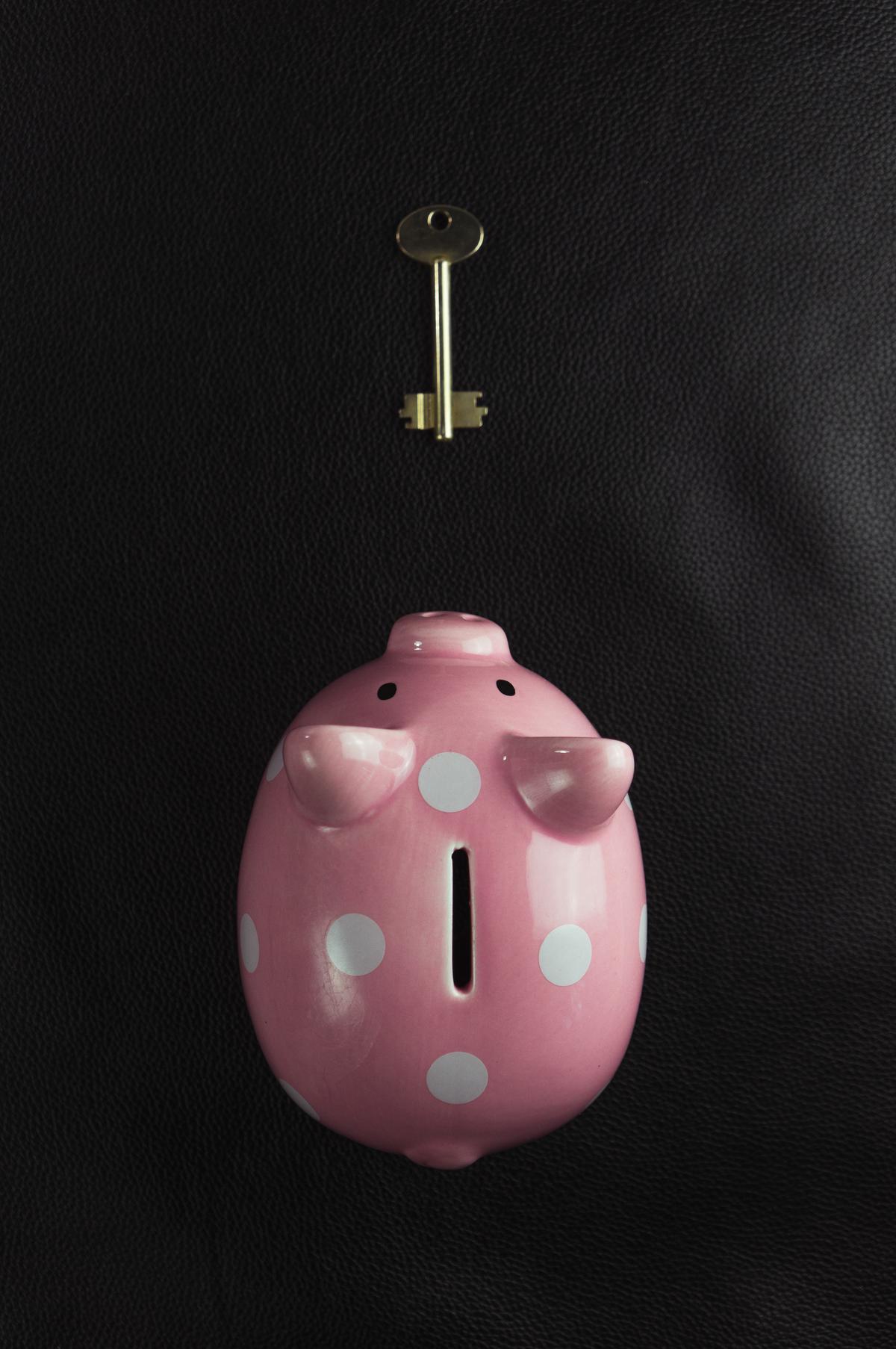 A piggy bank with a key indicating a backdoor route towards a Roth IRA account.
