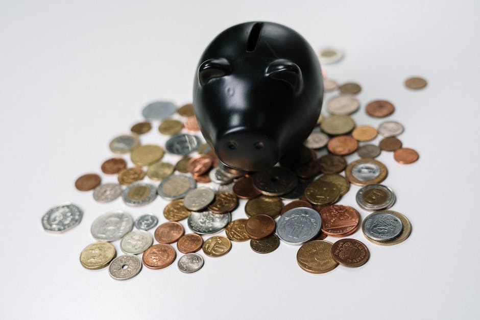 Image of a person holding a piggy bank with dollar signs on it, representing investing for compound interest