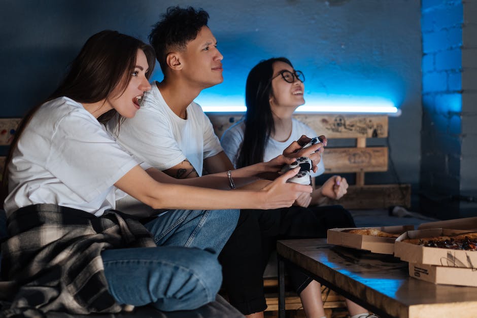 A group of people playing video games on computer screens, representing the world of blockchain gaming.