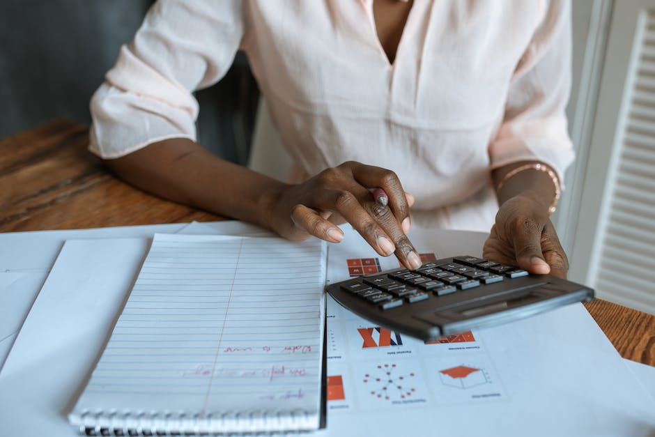 An image showing a person calculating financial figures.