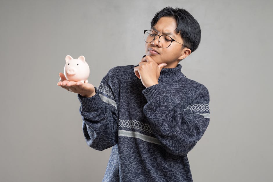 Image depicting a person holding a piggy bank with the text 'Understanding IRAs' written on it.