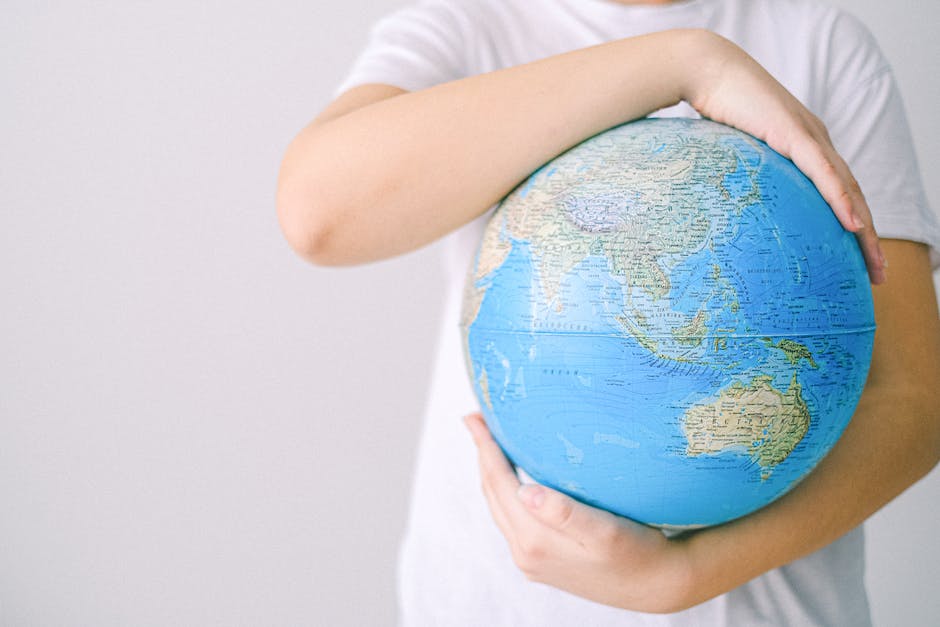 A businessman holding a globe, representing the concept of international investing